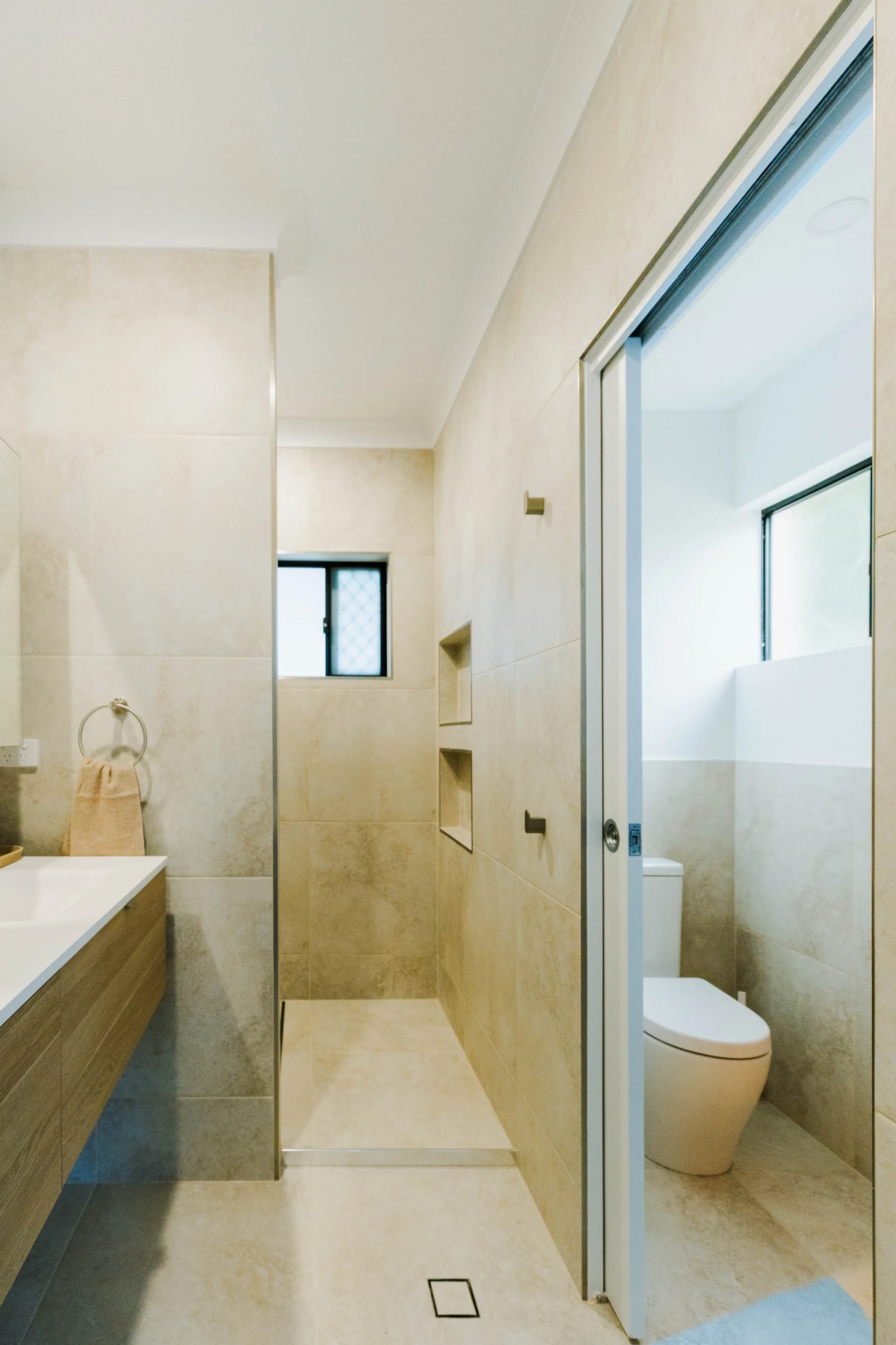 Legacy bathroom renovation — frameless shower with large format tiles