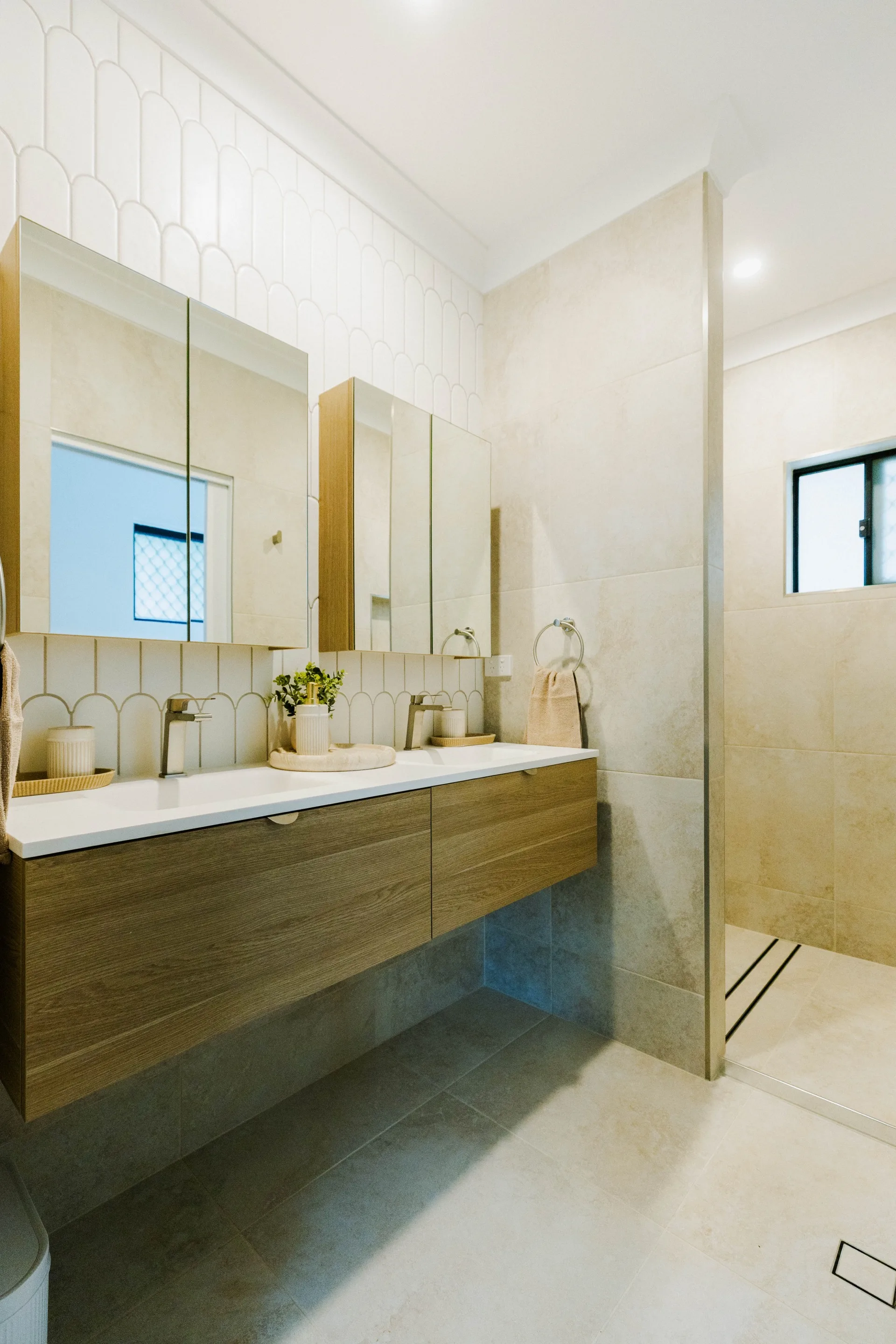 Legacy bathroom renovation — timber floating vanity with scallop tile feature wall