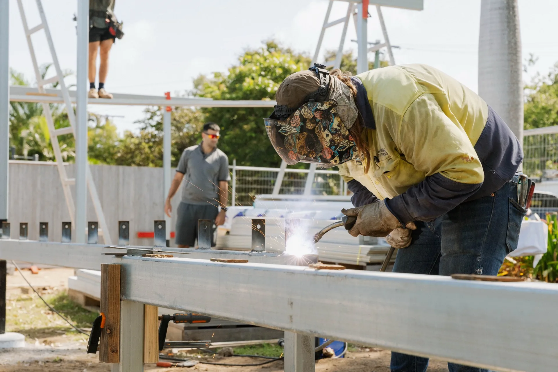 Legacy tradesman welding steel deck frame on site — North Queensland