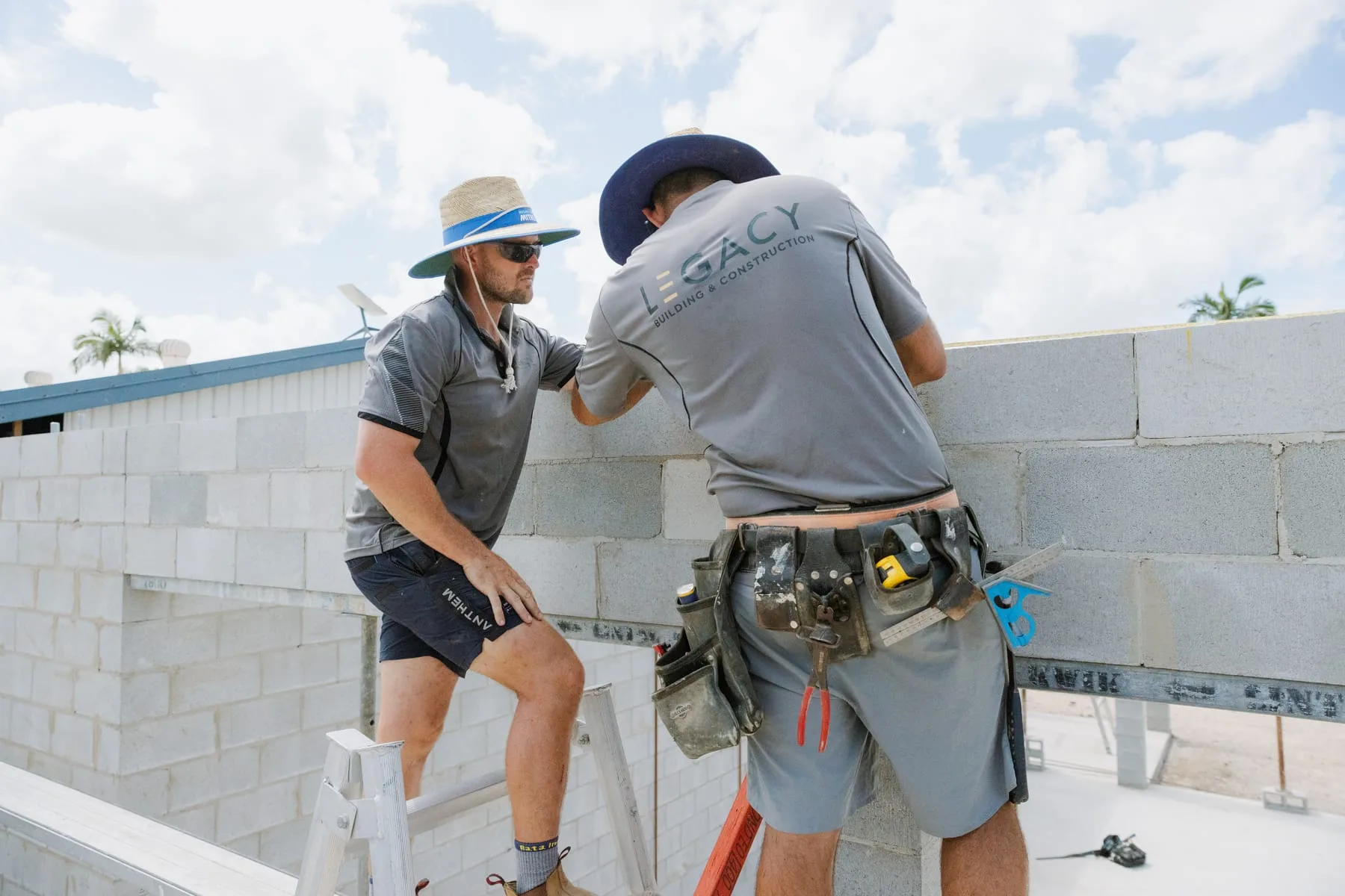 Legacy Building & Construction crew working on bond beam preparation atop the block walls at the Life Church Ingham extension