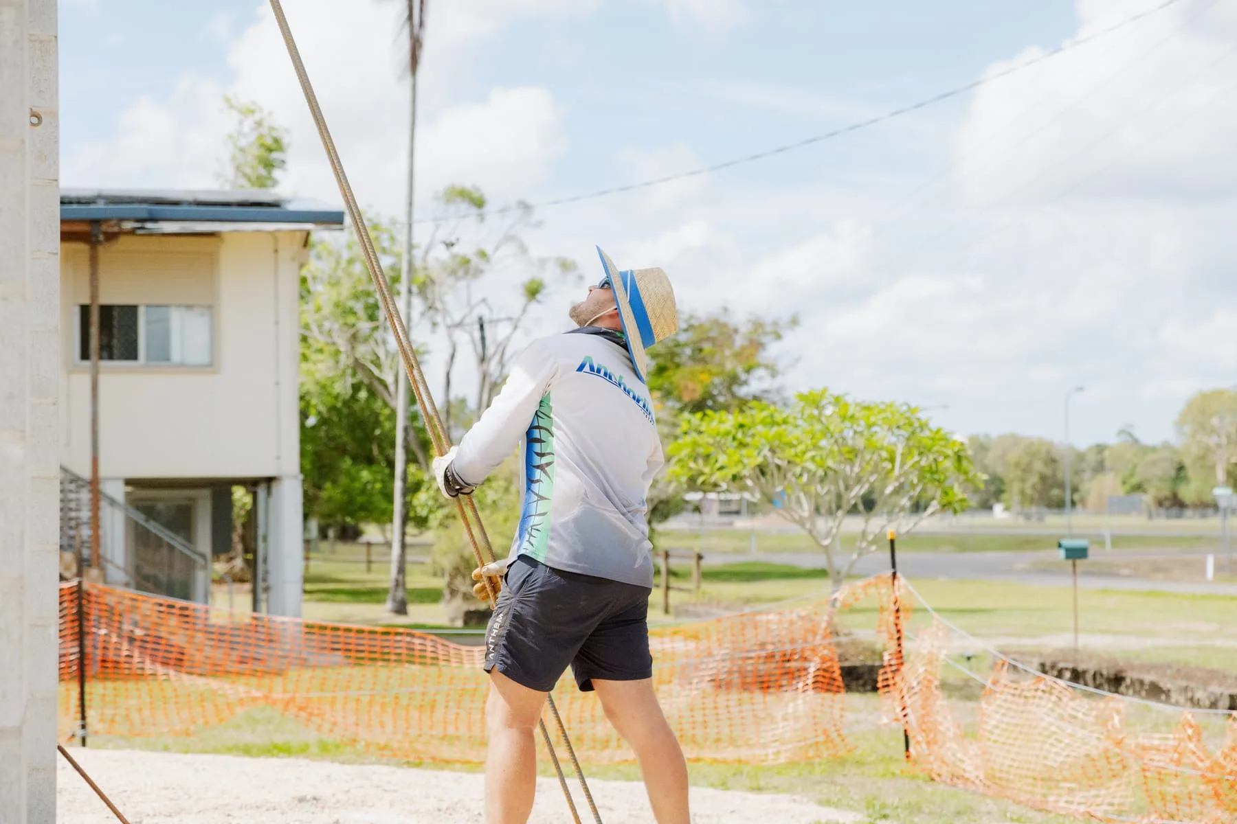 Legacy Building & Construction crew carrying steel reinforcement bars at the Life Church Ingham site