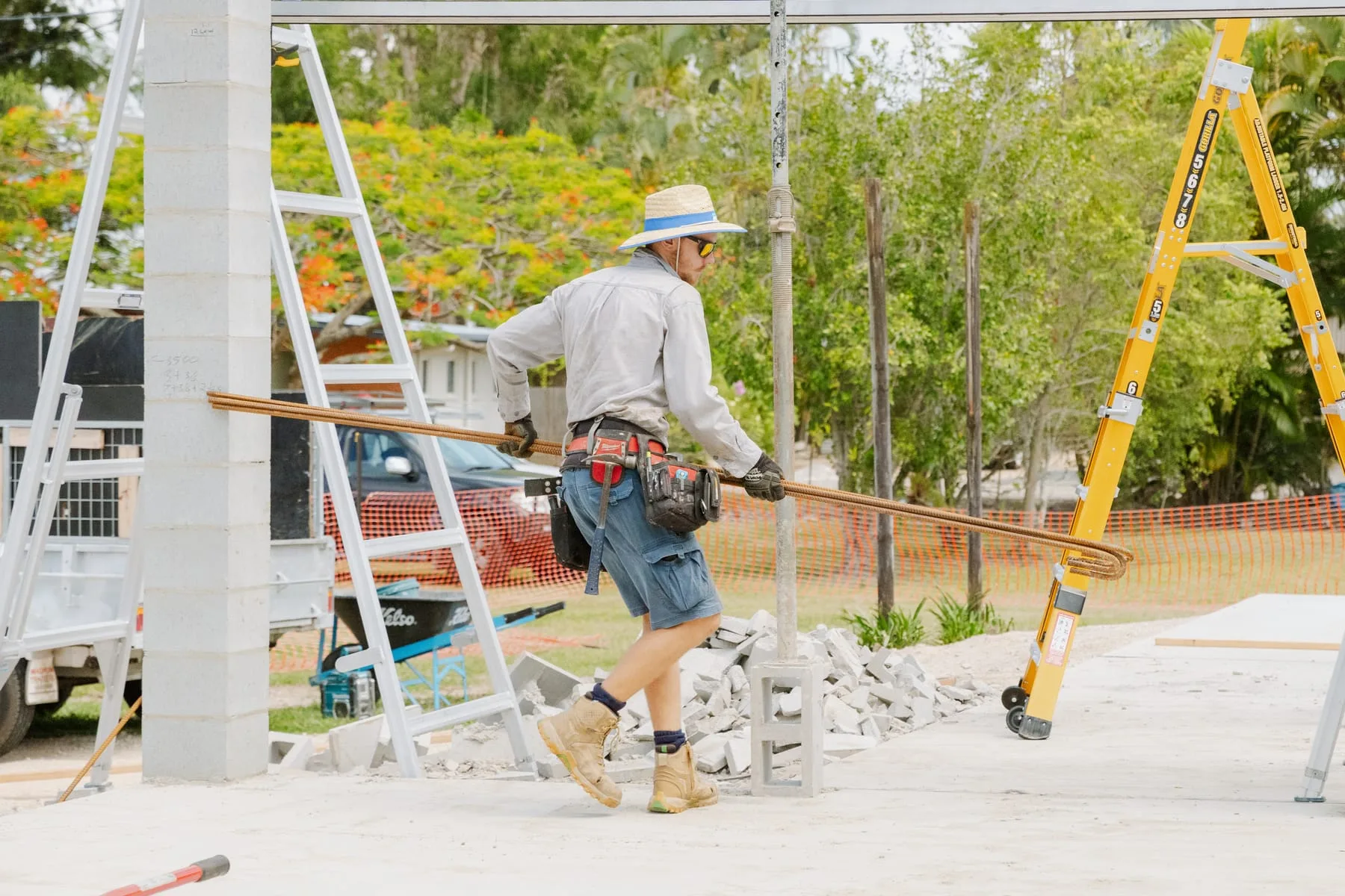 Legacy crew member moving steel reinforcement past structural piers at the Life Church Ingham extension