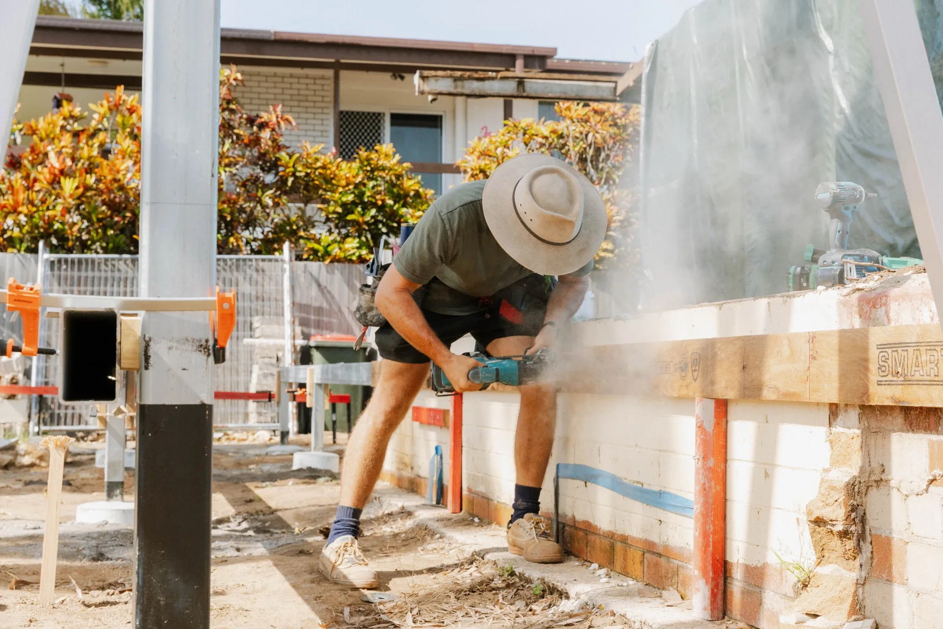 Legacy pool surround — builder working on pool block wall surround