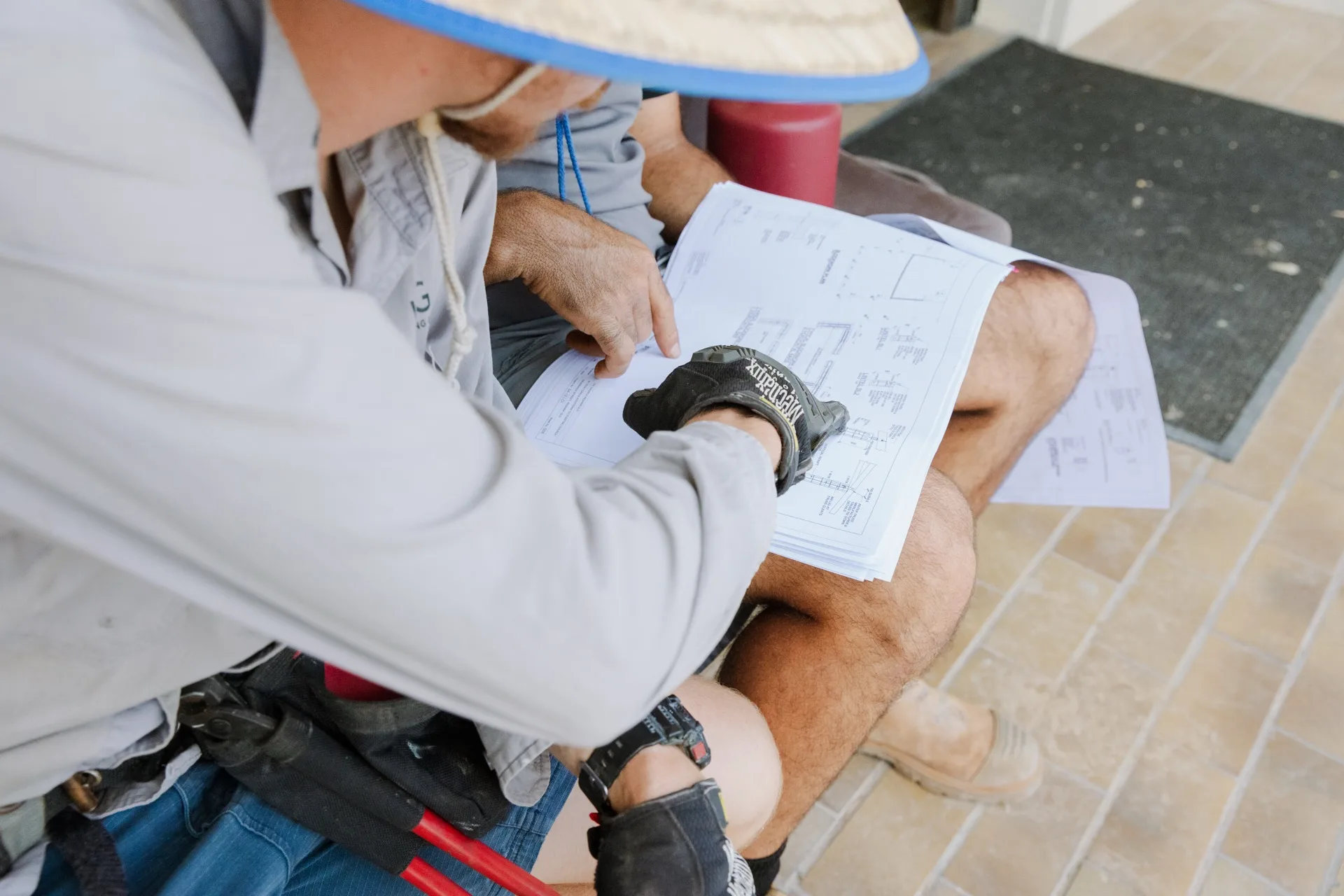 Legacy project manager reviewing construction drawings on site